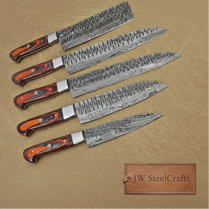 Handmade damascus steel knife with wood handle on dark surface