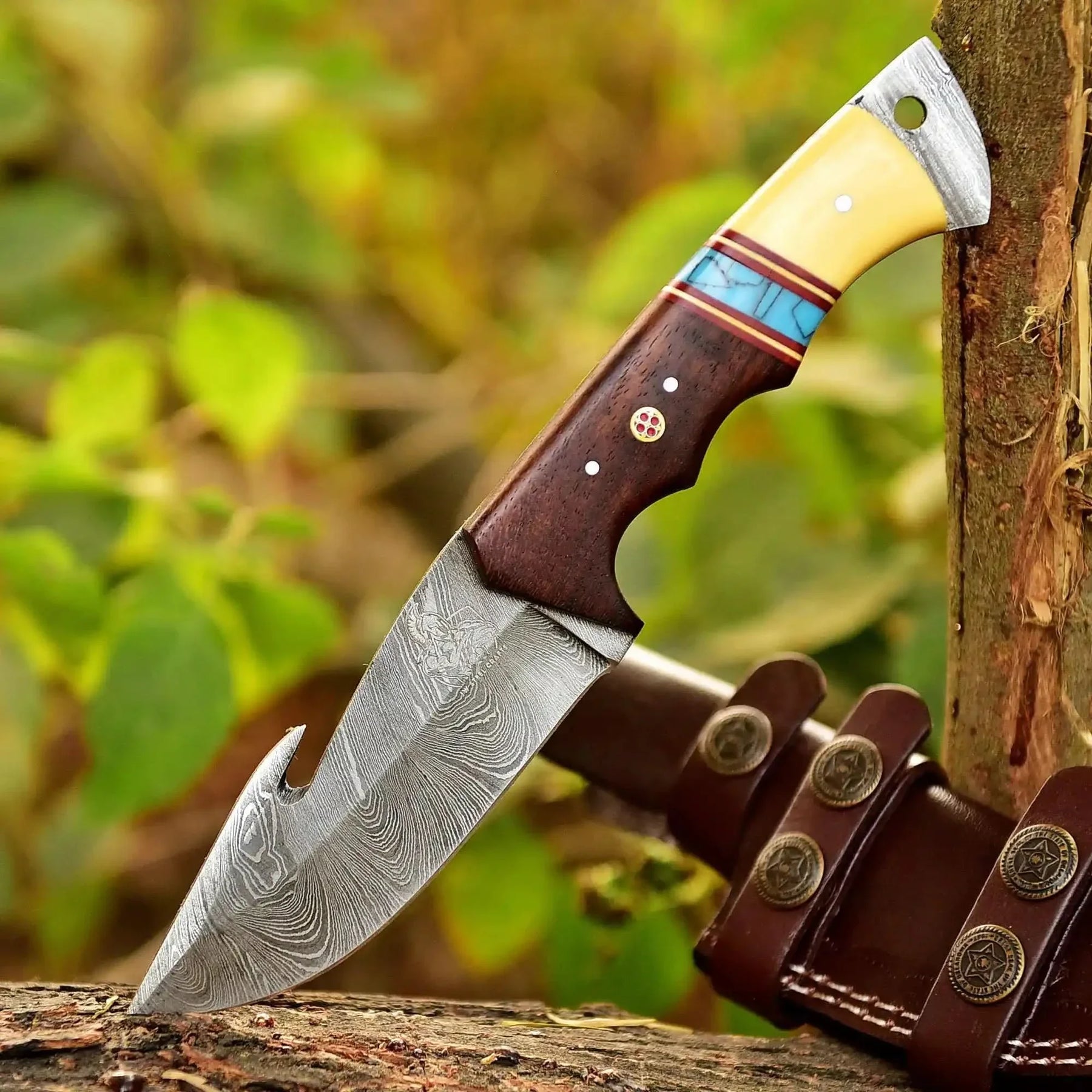 Handmade damascus steel knife with wood handle on dark surface