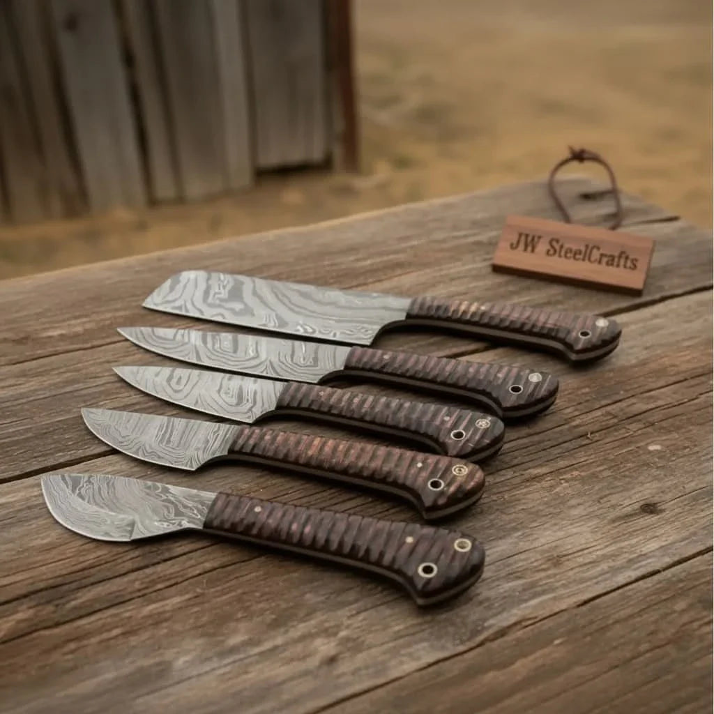 Handmade damascus steel knife with wood handle on dark surface