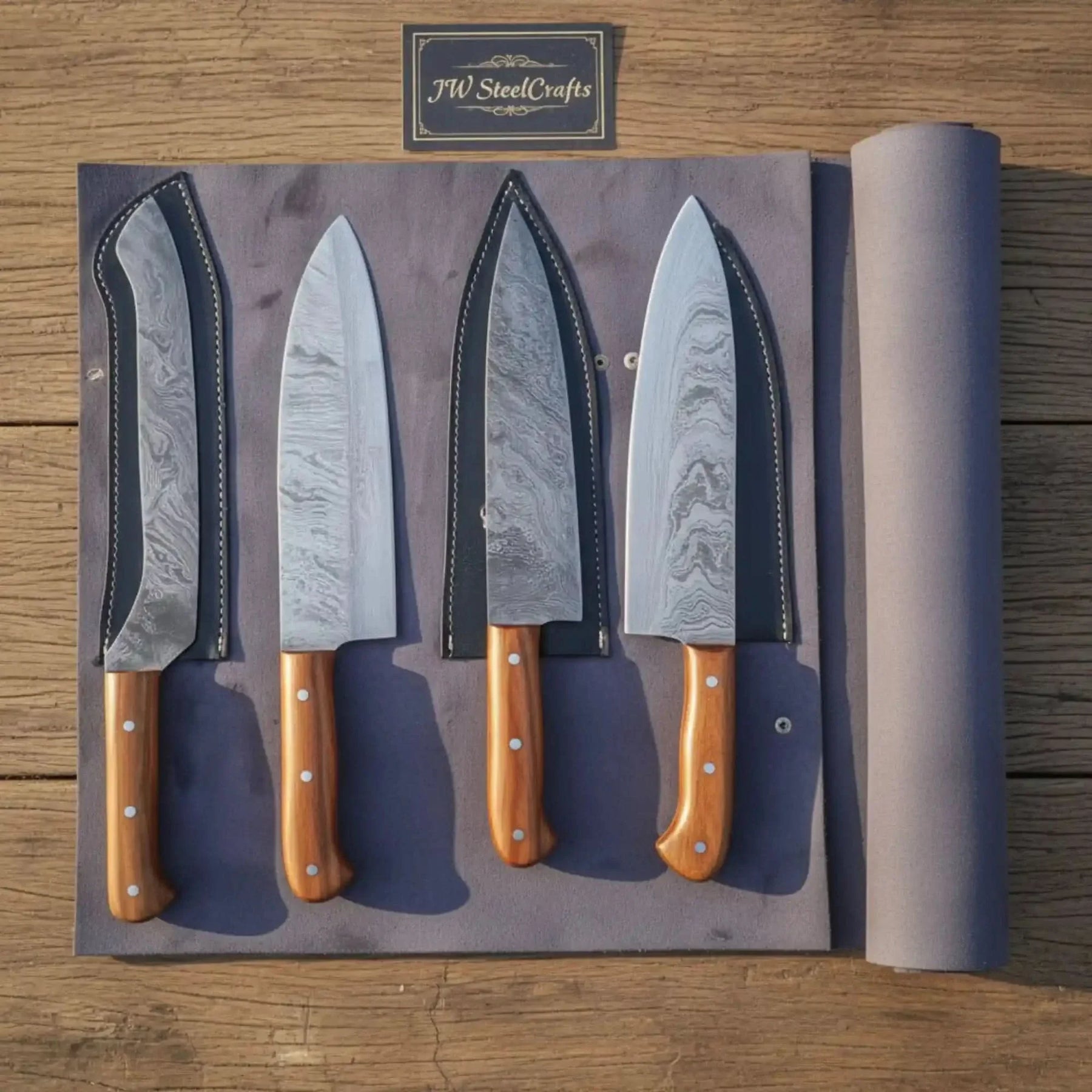 Handmade damascus steel knife with wood handle on dark surface