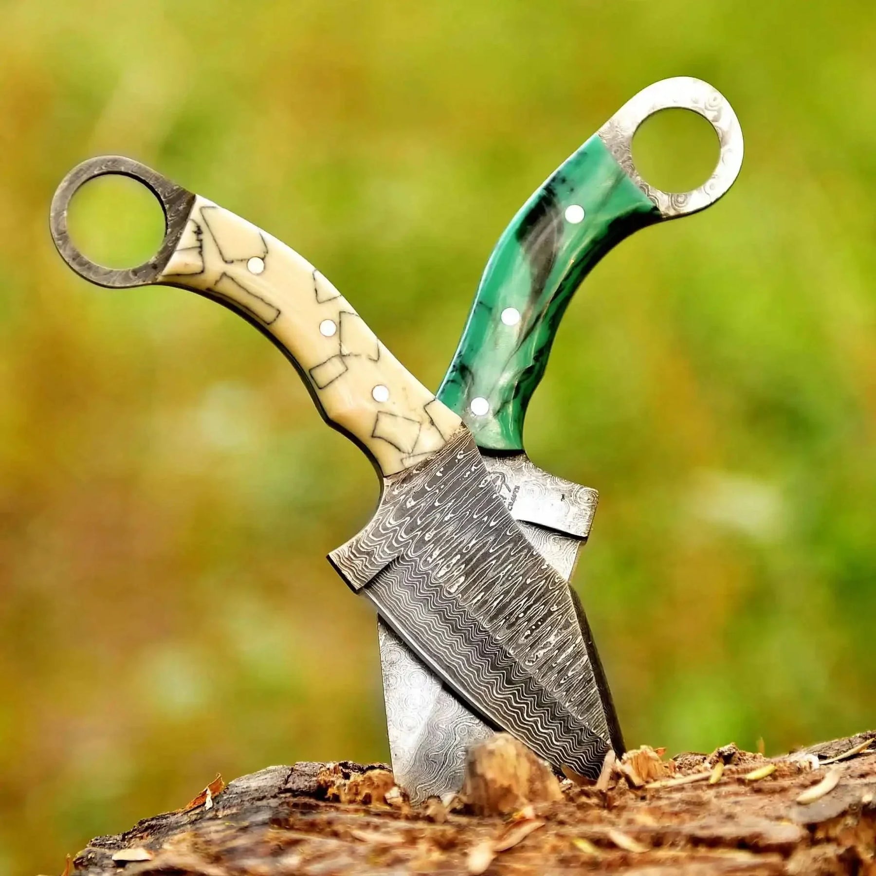 Handmade damascus steel knife with bone handle on dark surface