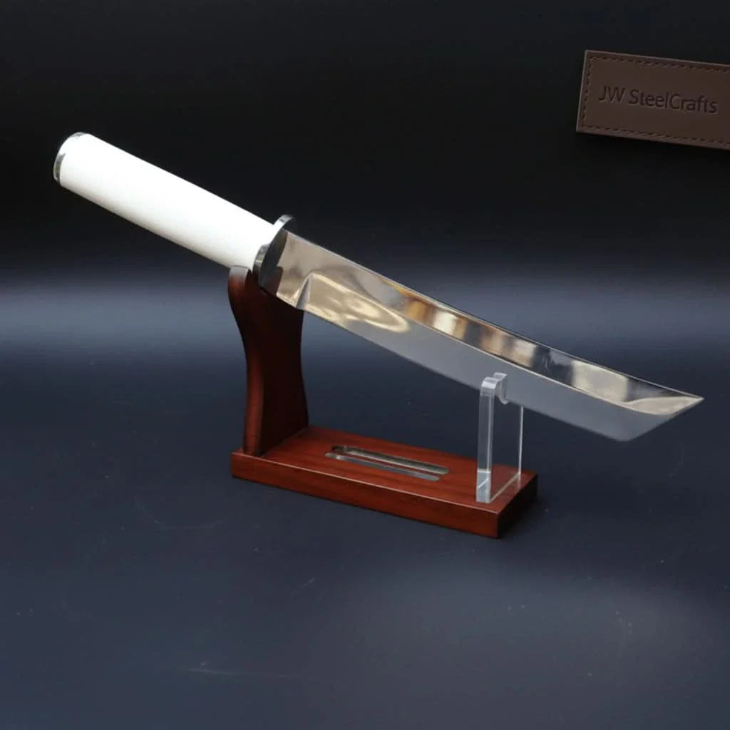 Handmade damascus steel knife with premium handle on dark surface