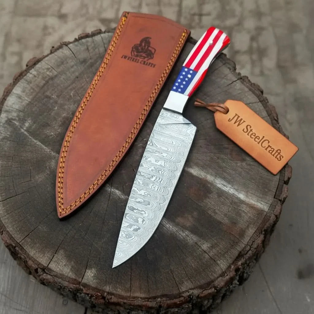 Handmade damascus steel knife with resin handle on dark surface