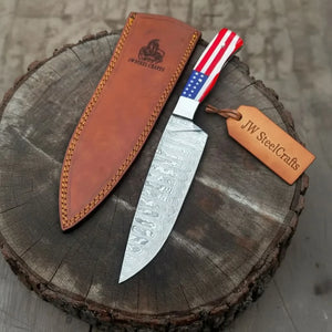 Handmade damascus steel knife with resin handle on dark surface
