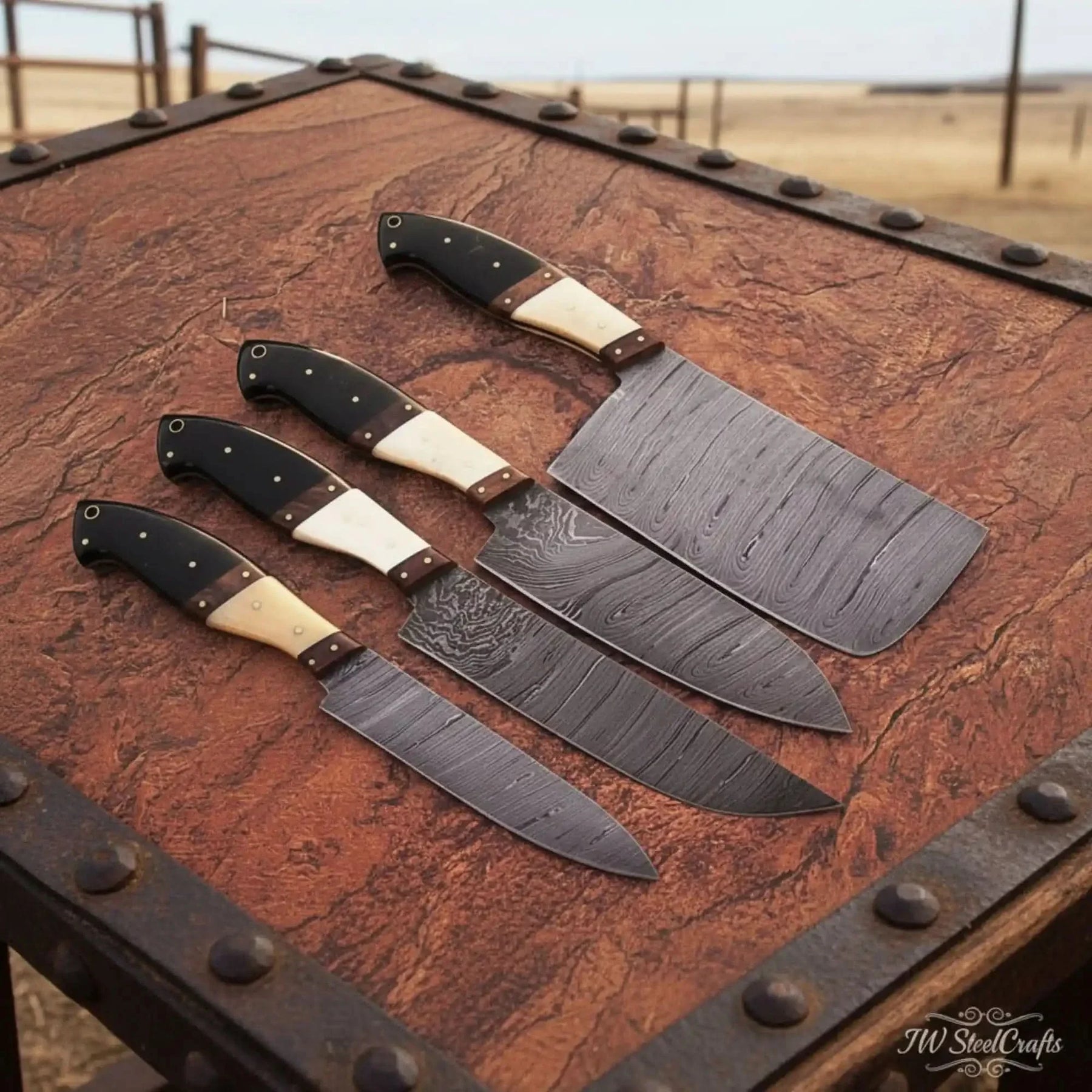 Handmade damascus steel knife with wood handle on dark surface