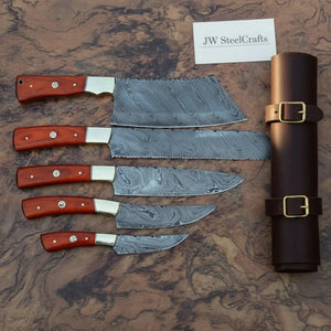 Handmade damascus steel knife with wood handle on dark surface
