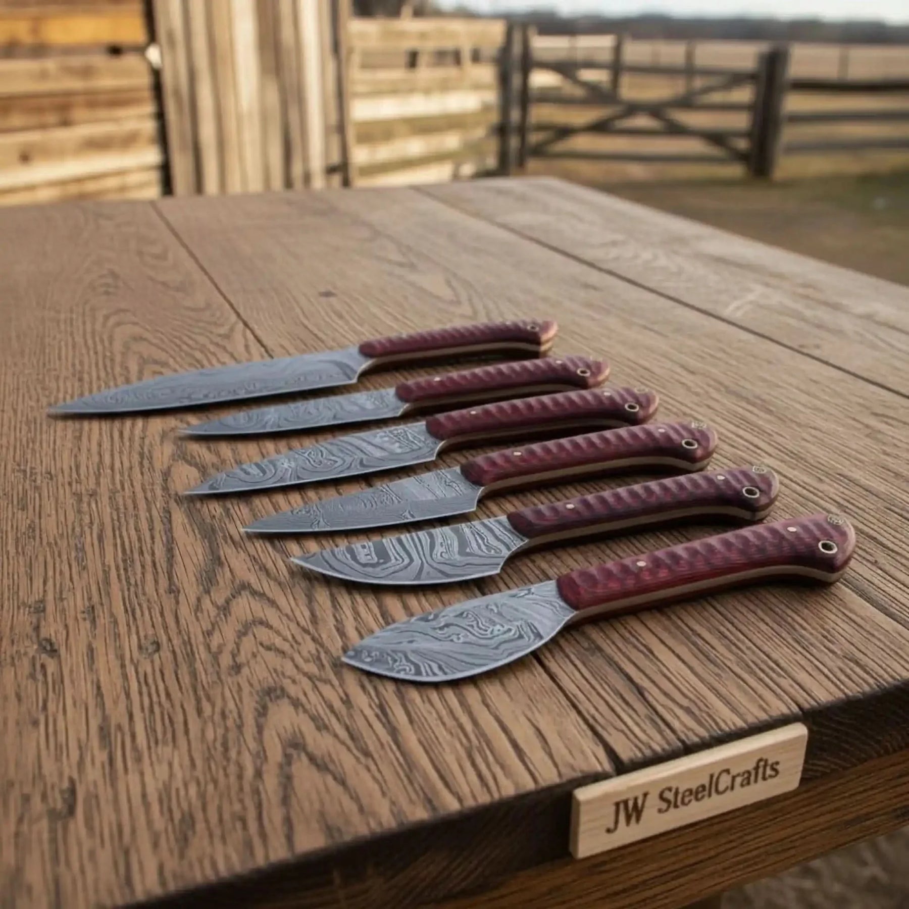 Handmade damascus steel knife with wood handle on dark surface