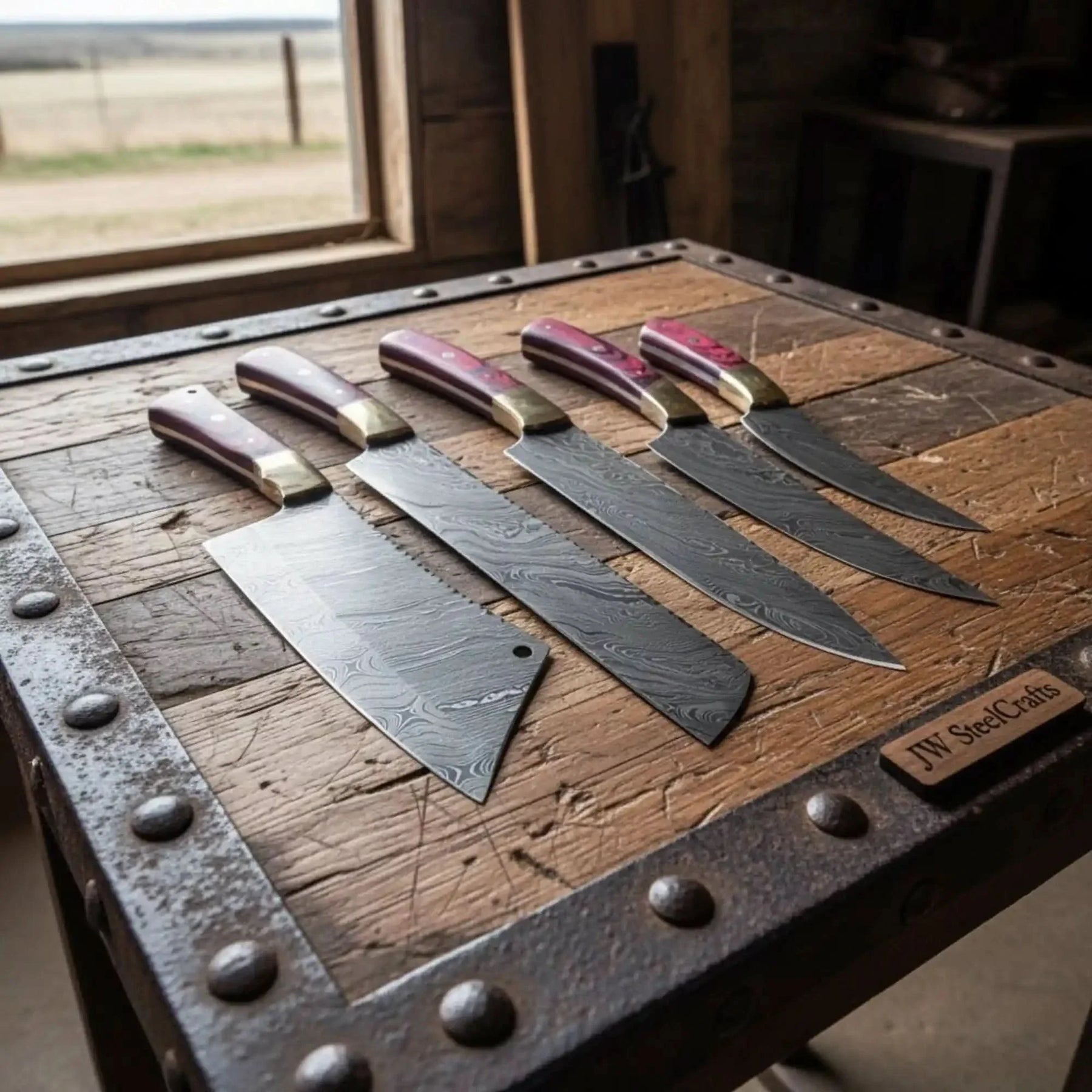Handmade damascus steel knife with wood handle on dark surface