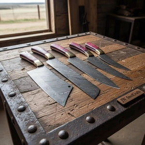 Handmade damascus steel knife with wood handle on dark surface
