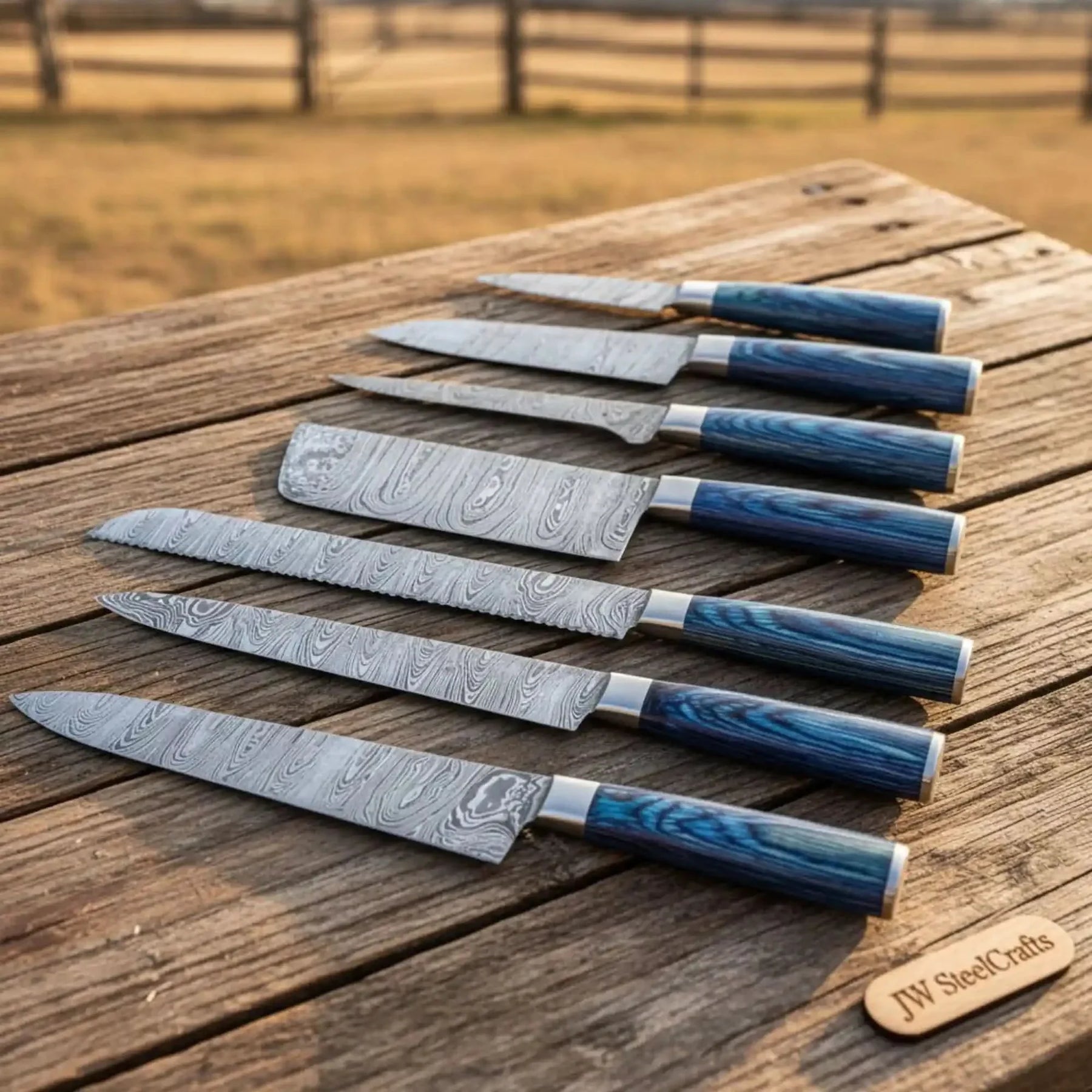 Handmade damascus steel knife with wood handle on dark surface