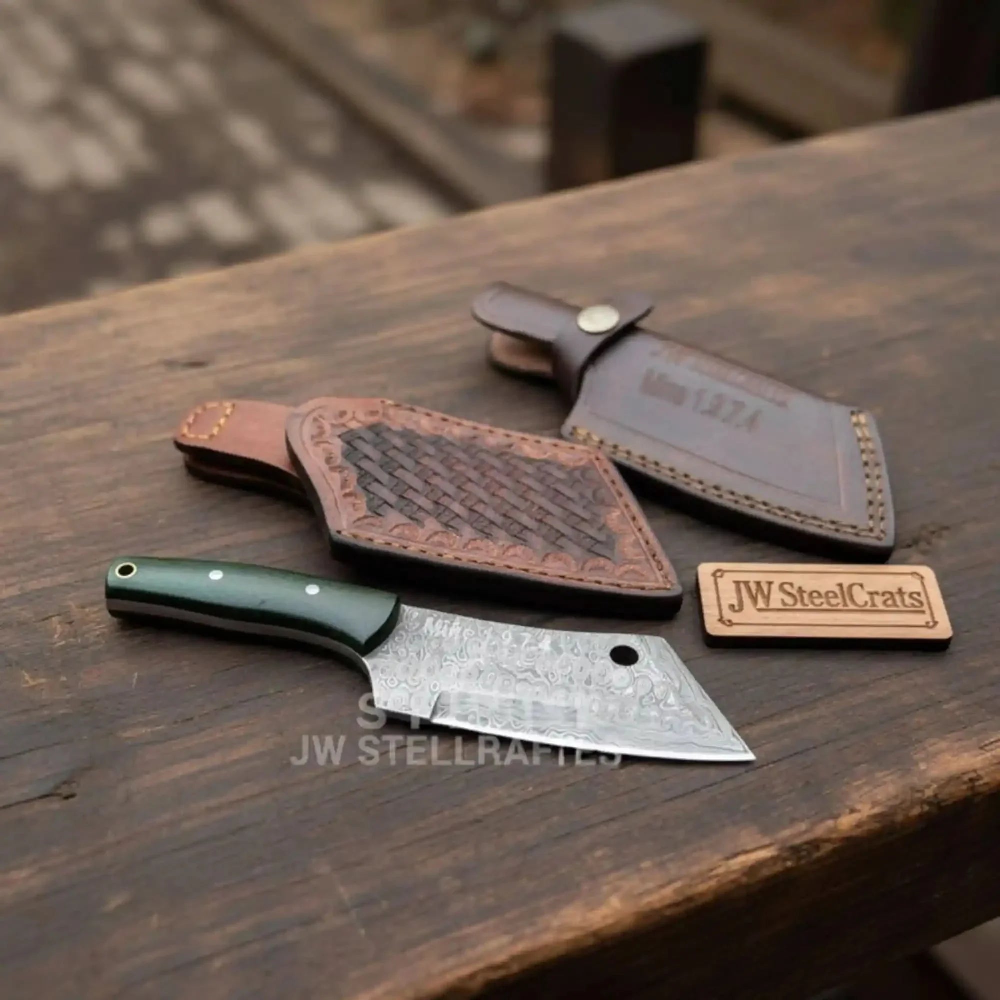 Handmade damascus steel knife with premium handle on dark surface