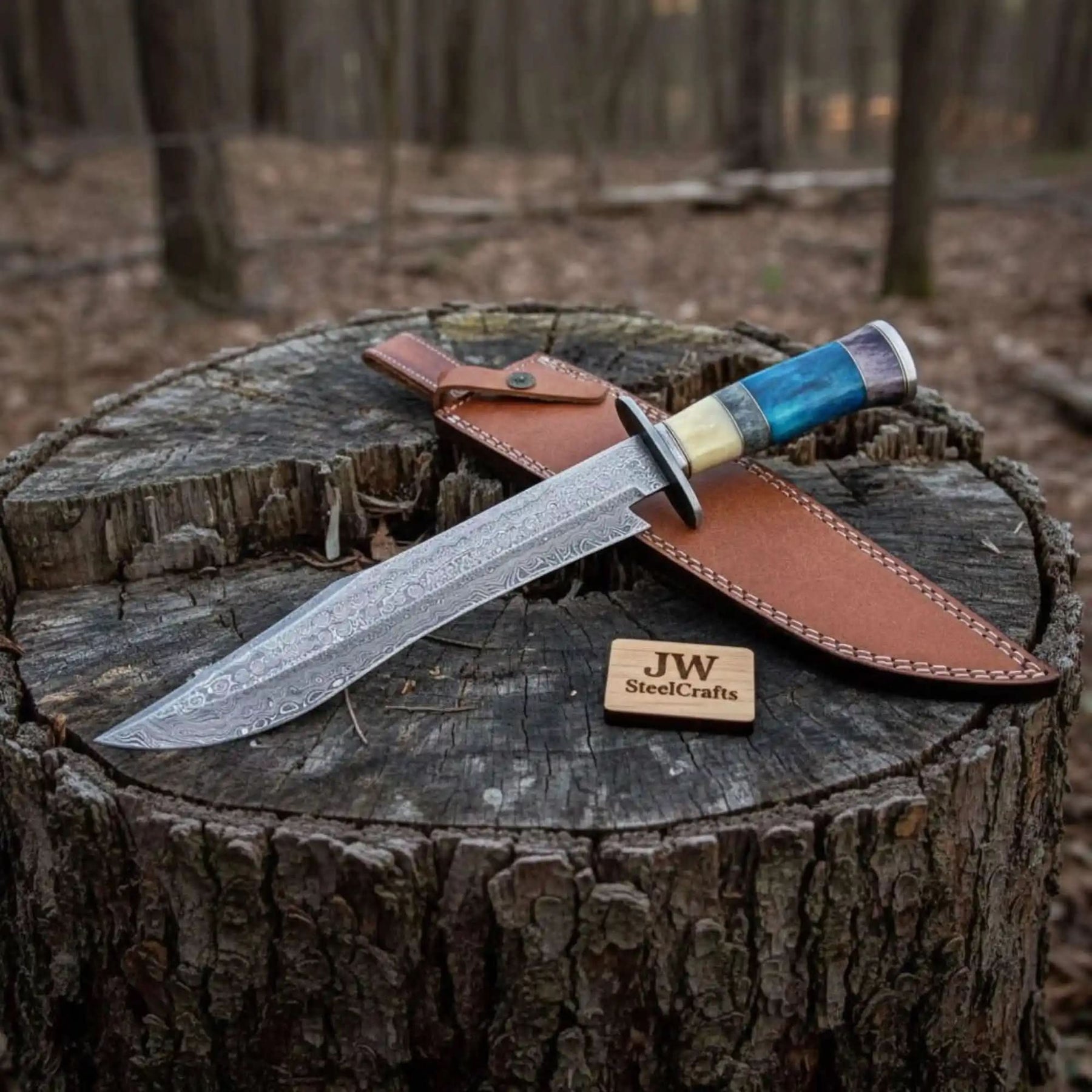 Handmade damascus steel knife with premium handle on dark surface