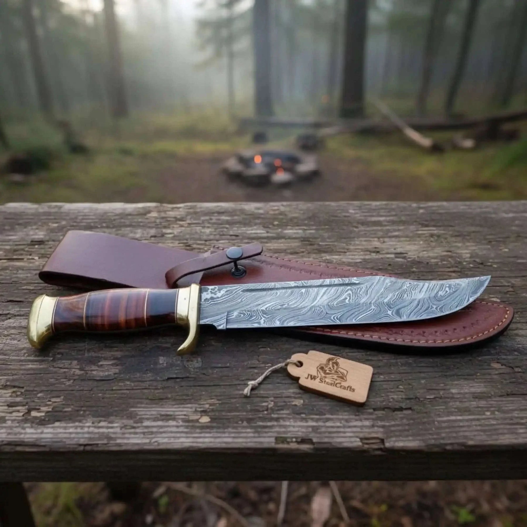 Handmade damascus steel knife with premium handle on dark surface