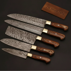 Handmade damascus steel knife with premium handle on dark surface