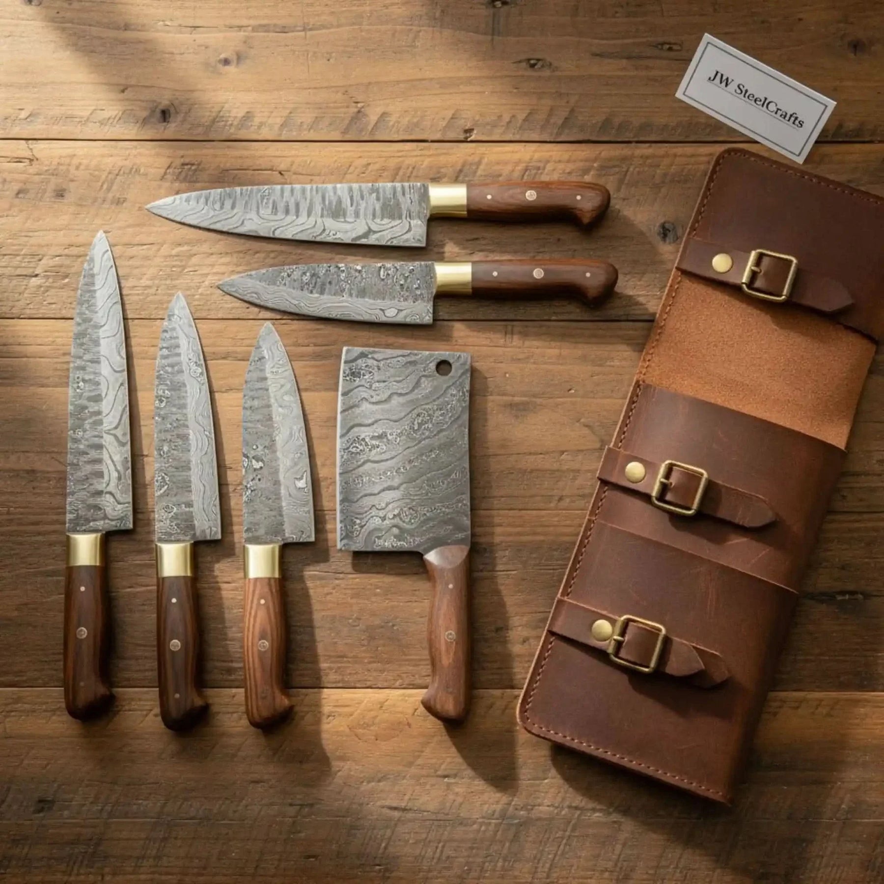 Handmade damascus steel knife with wood handle on dark surface