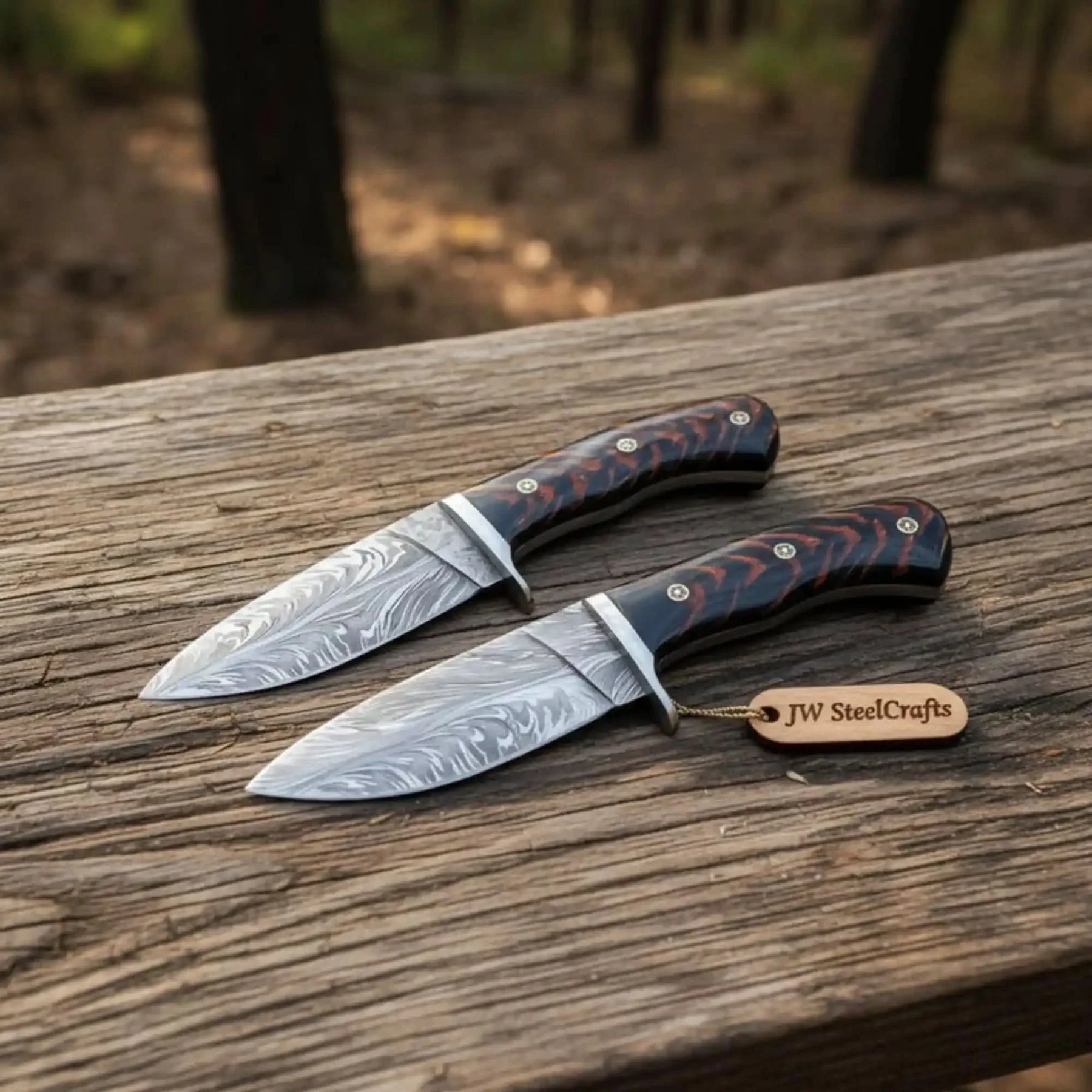 Handmade damascus steel knife with premium handle on dark surface