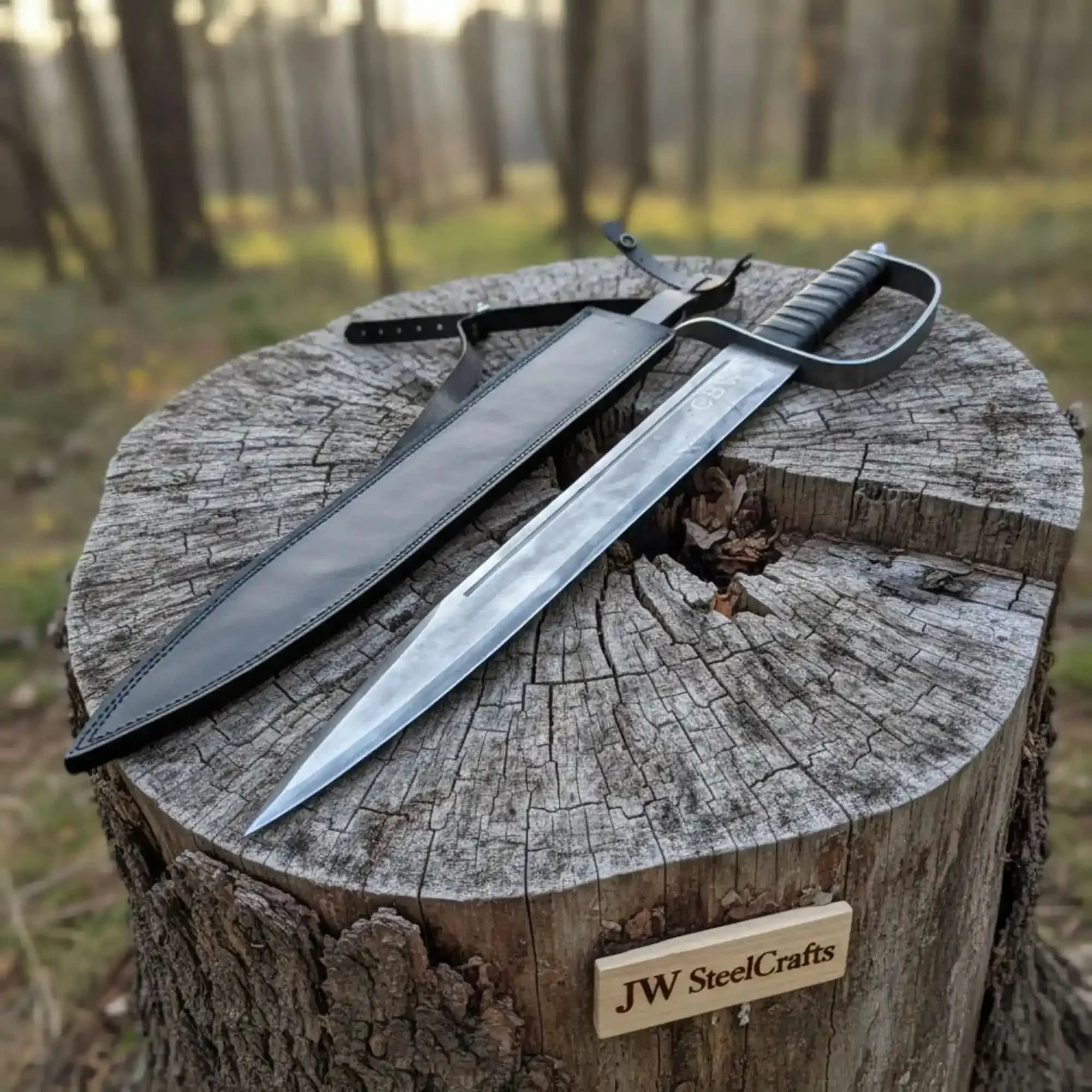 Full-length damascus steel replica sword with leather handle on dark background