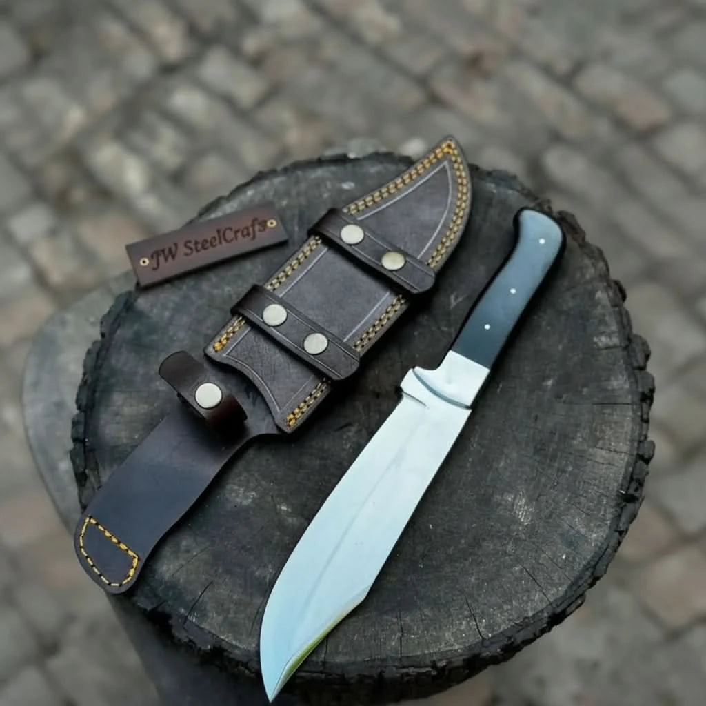 Handmade damascus steel knife with micarta handle on dark surface