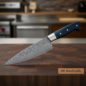 Handmade damascus steel knife with micarta handle on dark surface