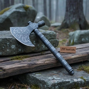 Damascus steel axe head with wood handle on rustic wood surface