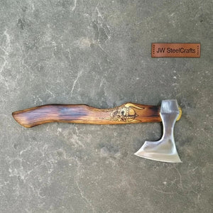 Stainless steel steel axe head with wood handle on rustic wood surface