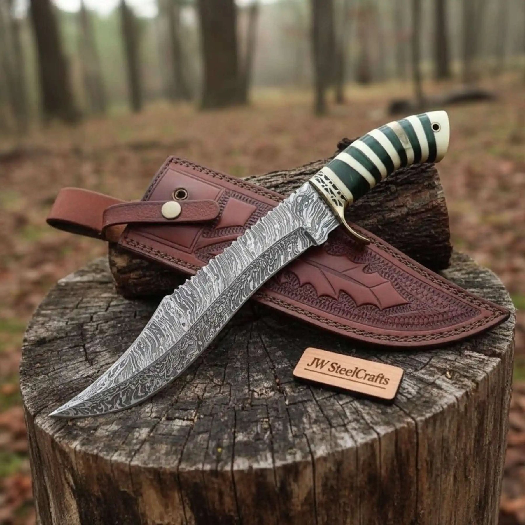 Handmade damascus steel knife with premium handle on dark surface