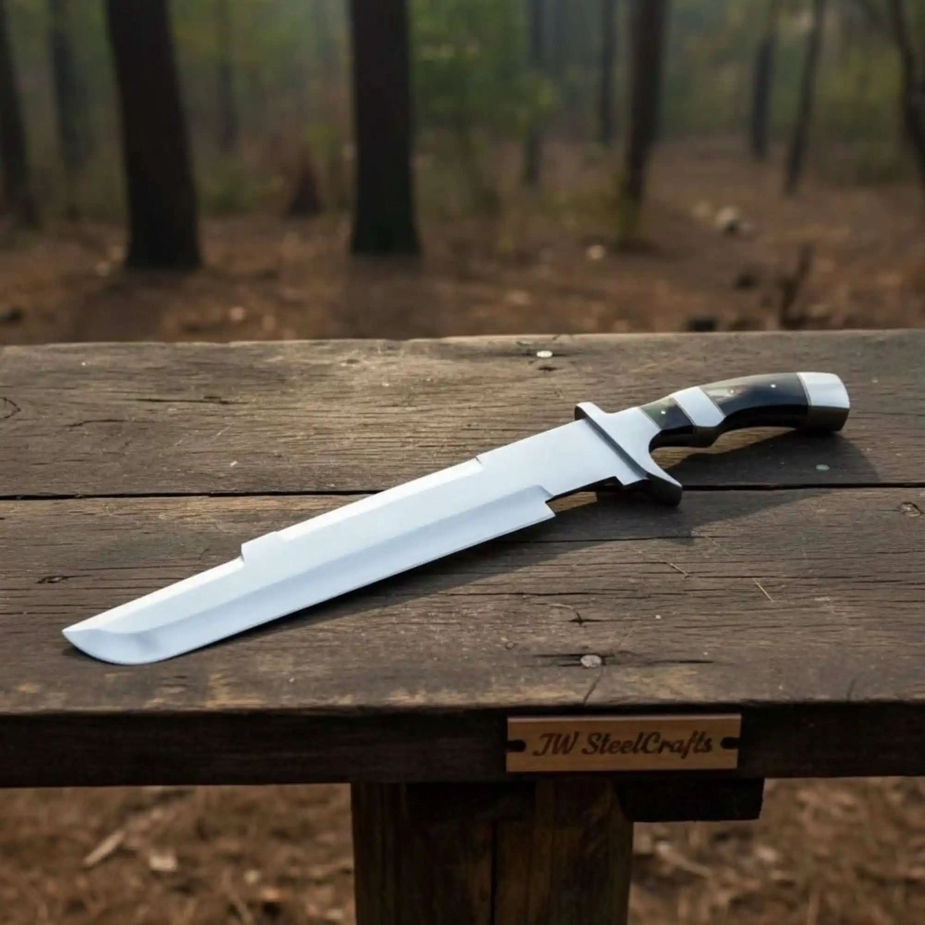 Handmade damascus steel knife with premium handle on dark surface