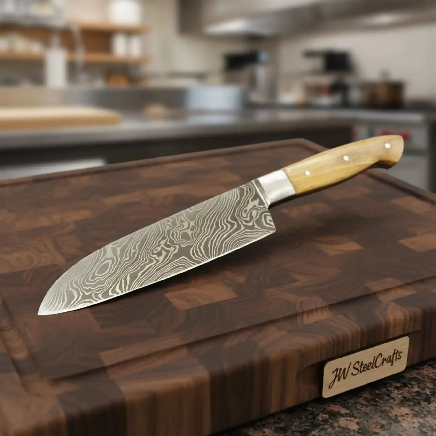 Handmade damascus steel knife with wood handle on dark surface