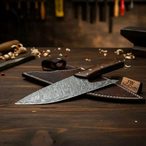 Handmade damascus steel knife with wood handle on dark surface