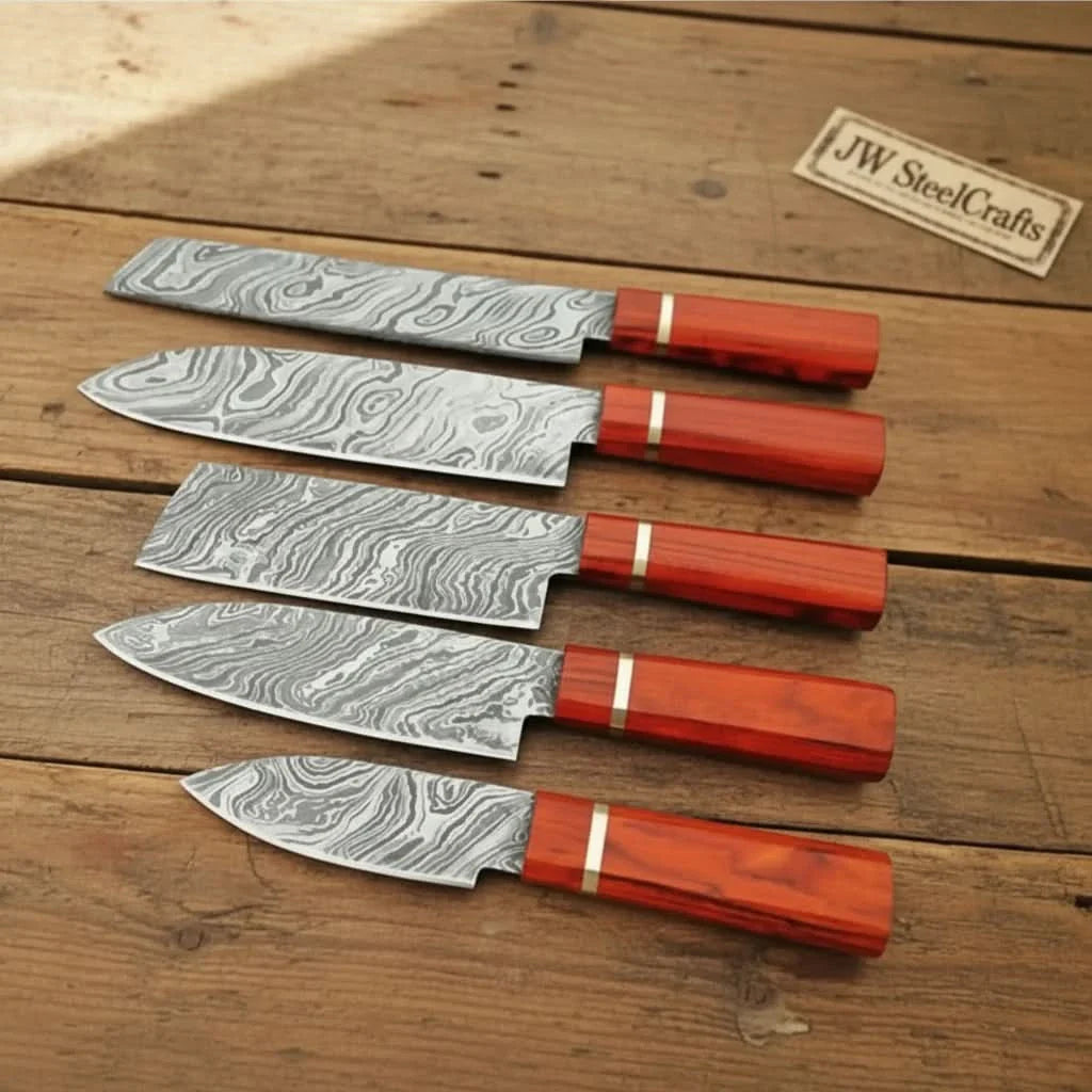 Handmade damascus steel knife with wood handle on dark surface