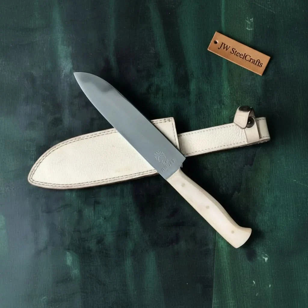 Handmade damascus steel knife with micarta handle on dark surface
