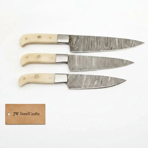 Handmade damascus steel knife with bone handle on dark surface