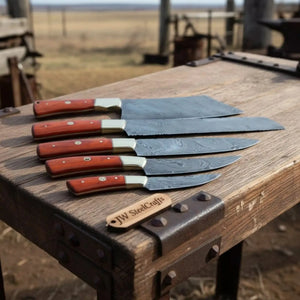 Handmade damascus steel knife with wood handle on dark surface