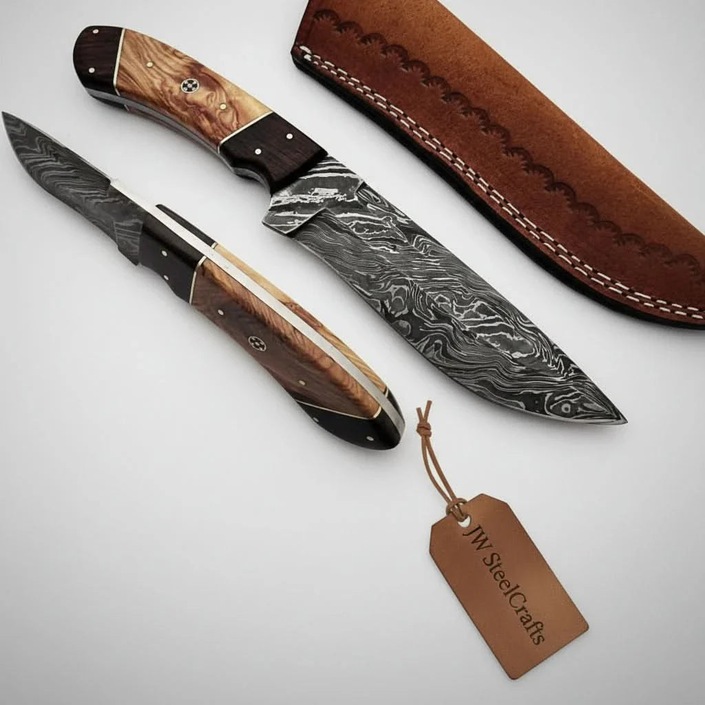 Handmade damascus steel knife with premium handle on dark surface