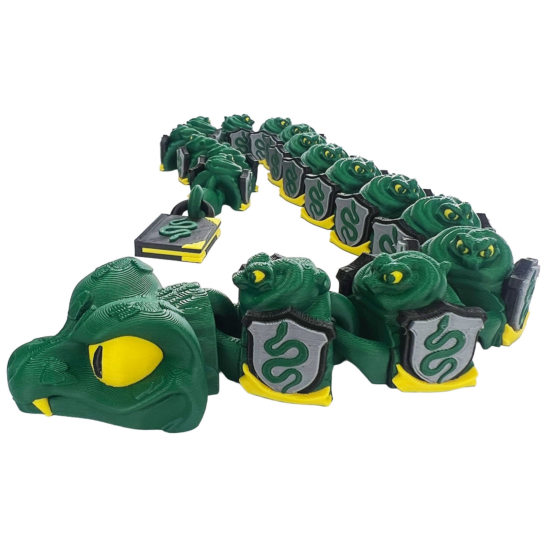 Professor Snake articulated 3D printed serpent shown in a curved pose with green shield segments and a book-shaped tail
