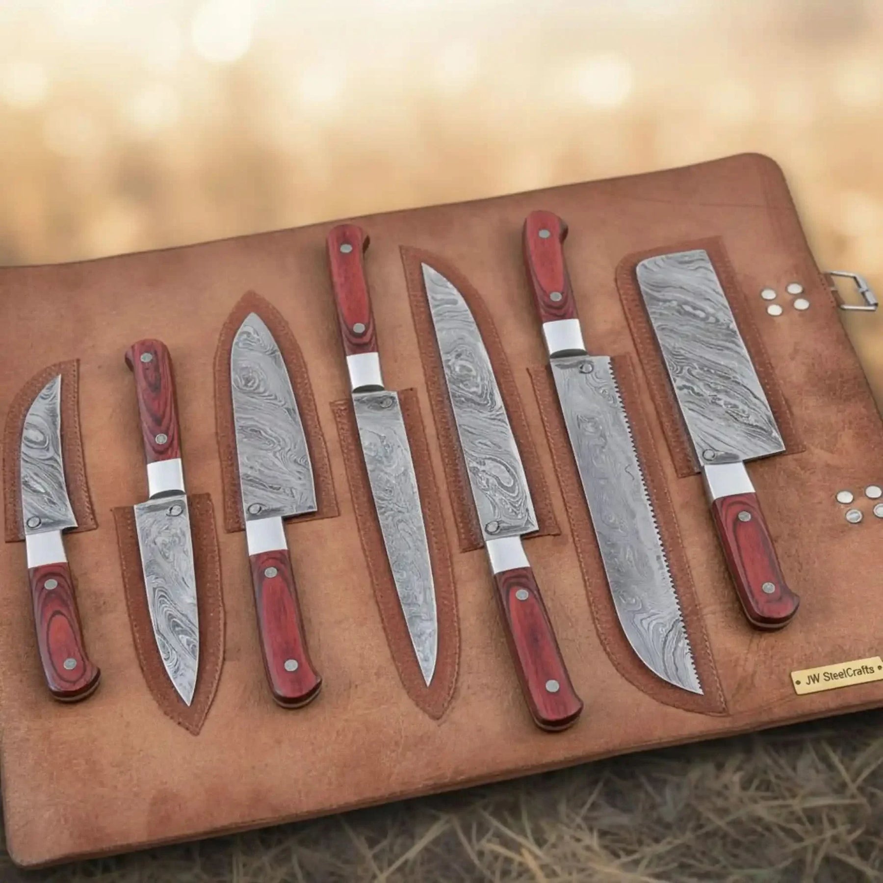 Handmade damascus steel knife with wood handle on dark surface