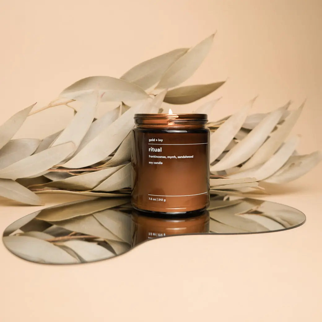 Brown glass soy candle with 'Ritual' label, featuring frankincense, myrrh, and sandalwood scent notes.