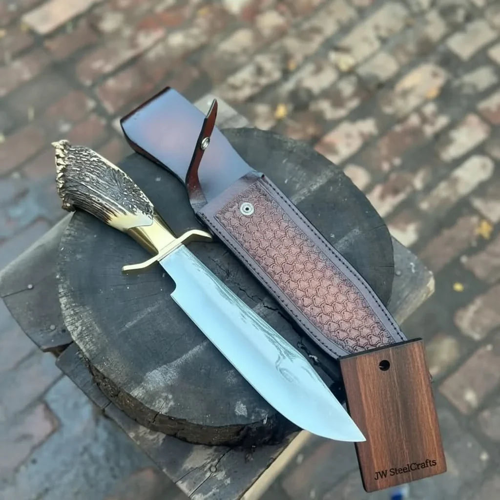 Handmade carbon steel steel knife with horn handle on dark surface