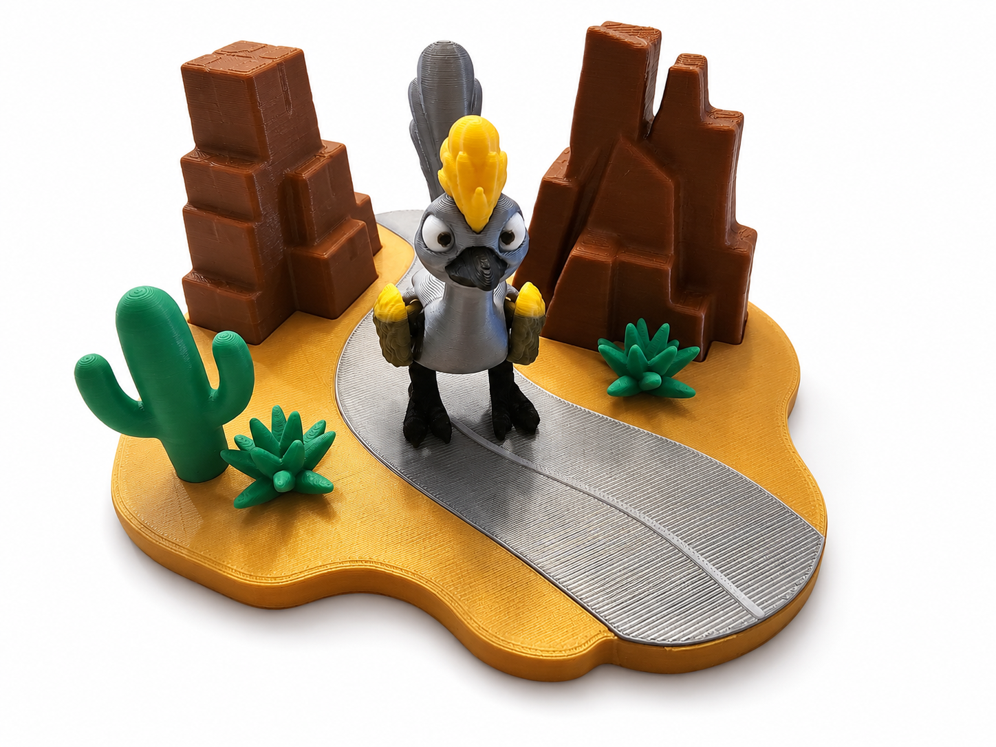 Front view of 3D printed roadrunner bird toy standing on desert road playset