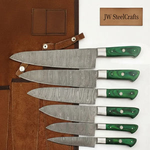 Handmade damascus steel knife with wood handle on dark surface