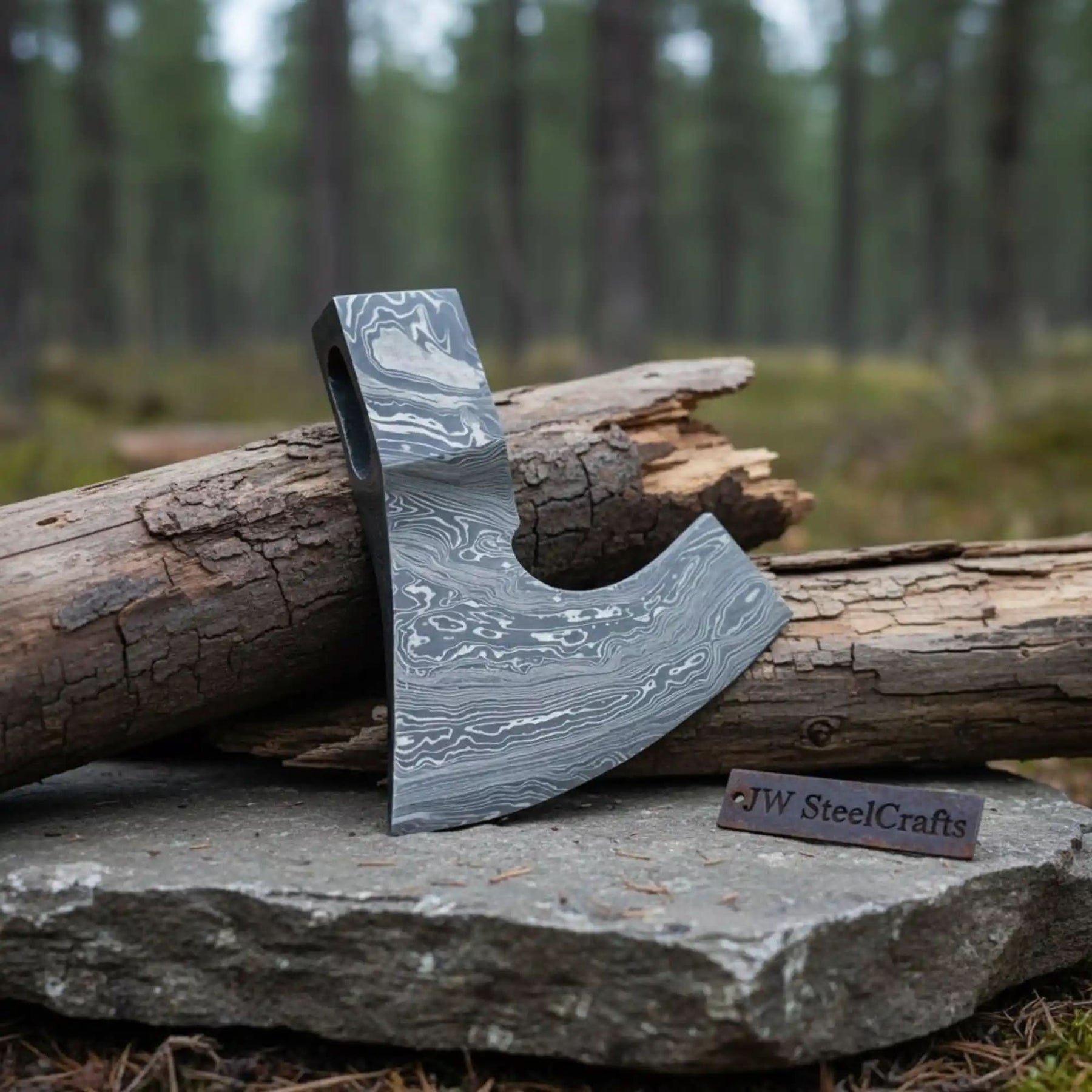 Damascus steel axe head with premium handle on rustic wood surface
