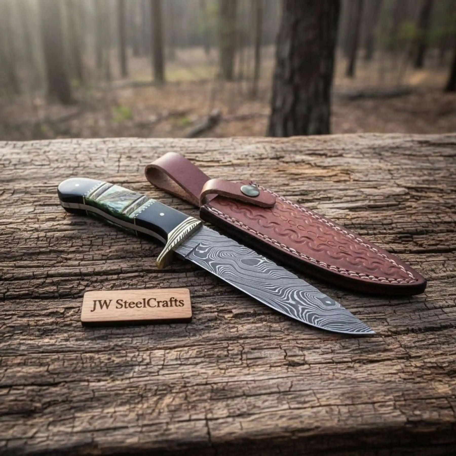 Handmade damascus steel knife with bone handle on dark surface