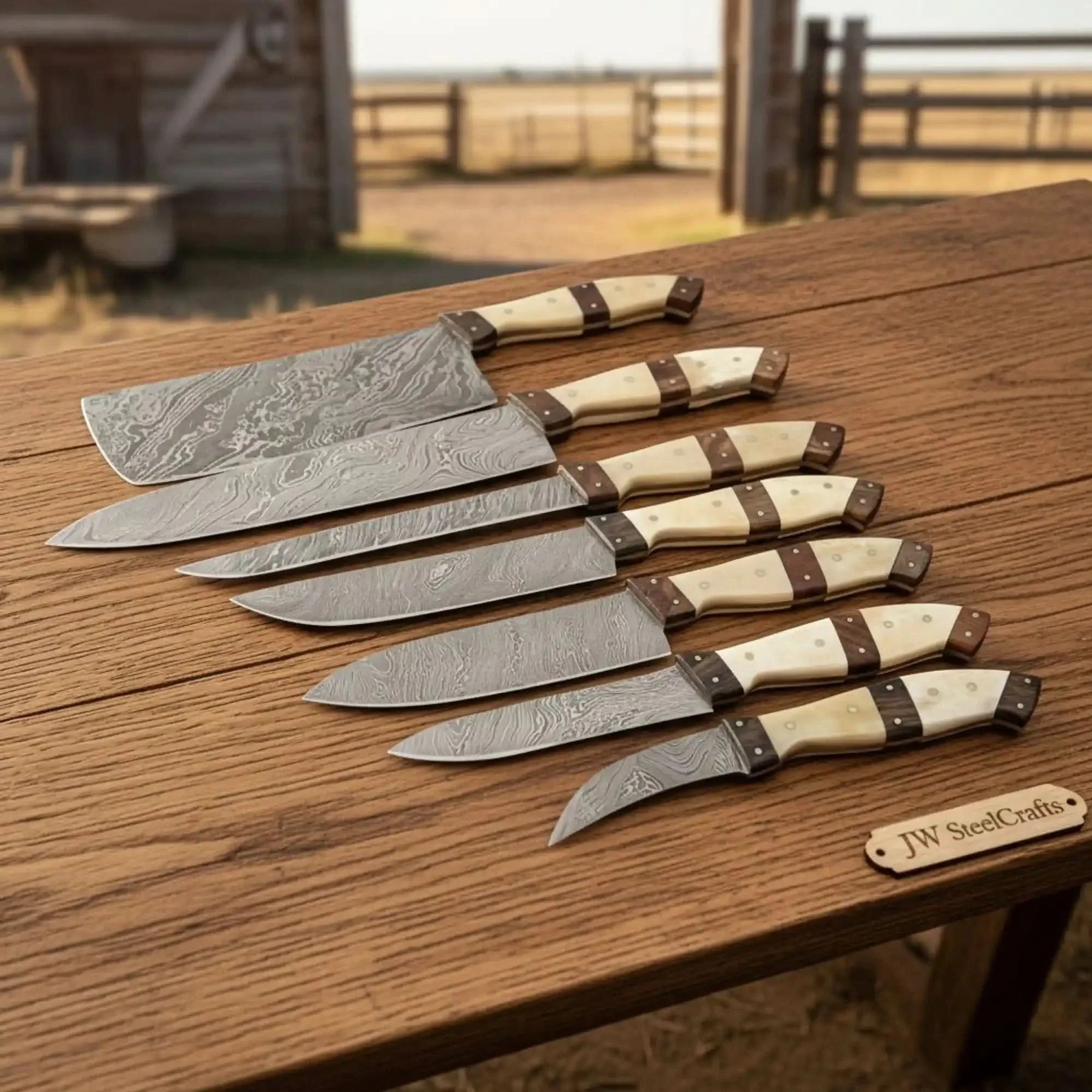 Handmade damascus steel knife with wood handle on dark surface