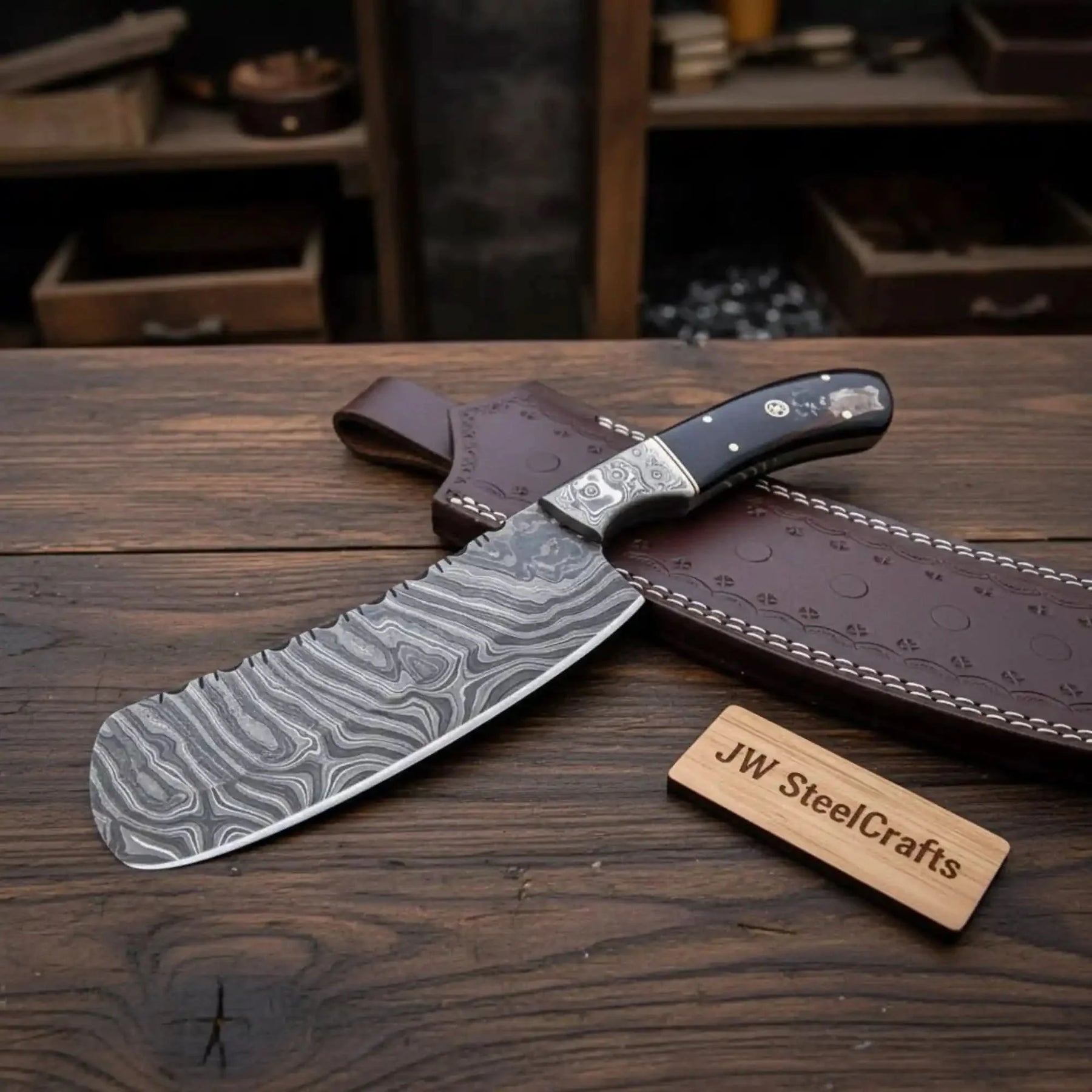 Handmade damascus steel knife with resin handle on dark surface