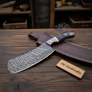 Handmade damascus steel knife with resin handle on dark surface