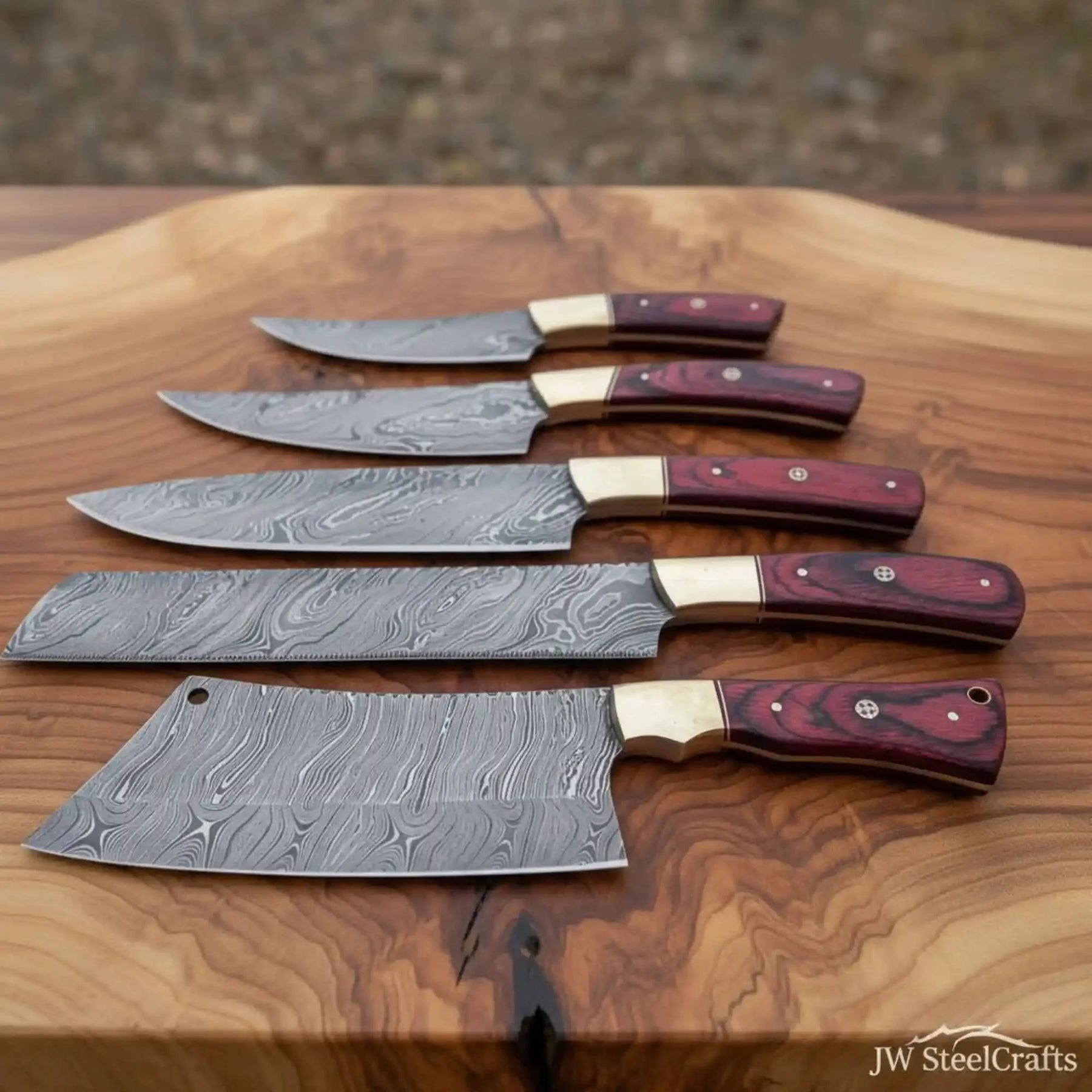 Handmade damascus steel knife with wood handle on dark surface