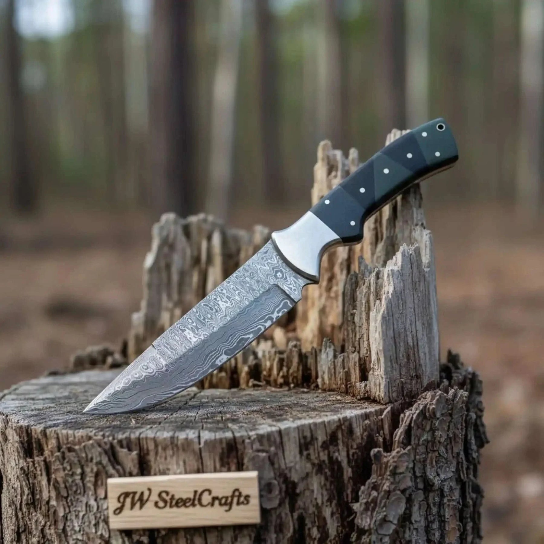 Handmade damascus steel knife with micarta handle on dark surface