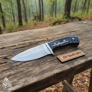 Handmade damascus steel knife with resin handle on dark surface