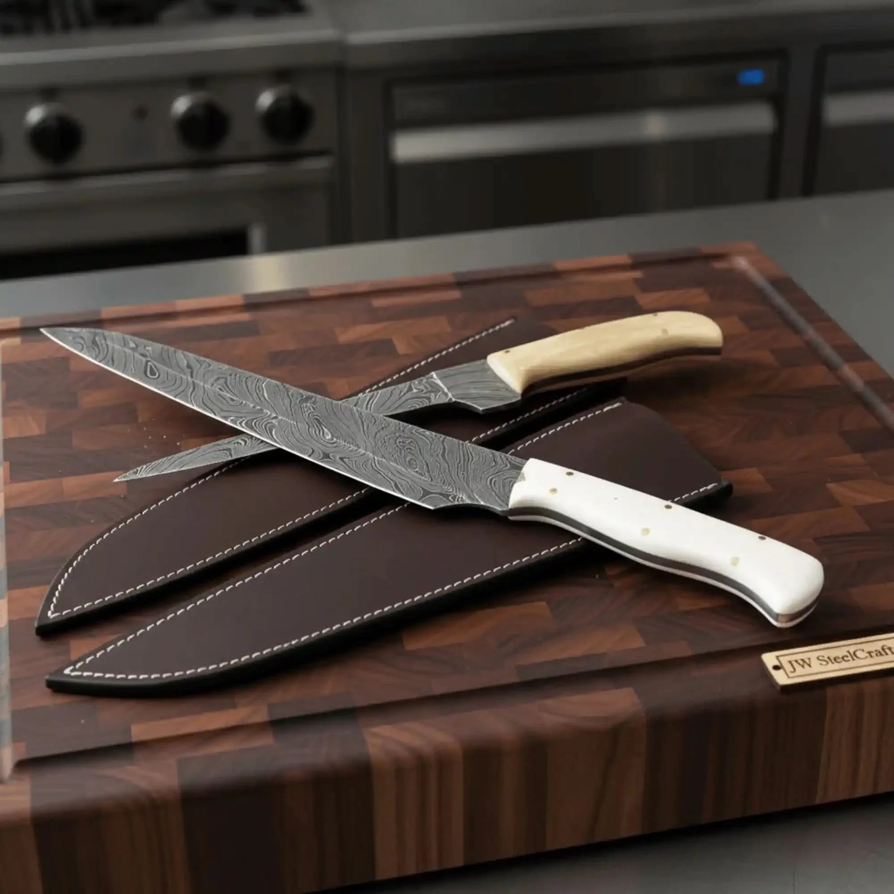Handmade damascus steel knife with bone handle on dark surface