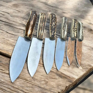 Handmade carbon steel steel knife with premium handle on dark surface